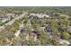 An aerial view of the house in the neighborhood, surrounded by mature trees at 162 Arbor W Dr, Palm Harbor, FL 34683