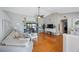 Comfortable living room featuring hardwood floors, neutral walls, a ceiling fan, and sliding glass doors to the backyard at 162 Arbor W Dr, Palm Harbor, FL 34683