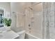 Bathroom with a shower and bath tub combo, a towel rack and plant on the countertop at 16724 Mooner Plank Cir, Wimauma, FL 33598