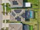 Aerial view of a home with solar panels and a backyard pool in a suburban neighborhood at 16946 Oval Rum Dr., Wimauma, FL 33598