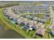 Aerial view of a neighborhood featuring well-maintained lawns and homes with swimming pools at 16946 Oval Rum Dr., Wimauma, FL 33598