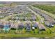 Aerial view of neighborhood featuring homes with manicured lawns and water views at 16946 Oval Rum Dr., Wimauma, FL 33598