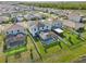 Beautiful aerial view of homes in a desirable neighborhood featuring pools, well-maintained lawns, and solar panels at 16946 Oval Rum Dr., Wimauma, FL 33598