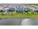 Scenic aerial shot of homes in a tranquil neighborhood, each boasting a private screened pool and lush backyard at 16946 Oval Rum Dr., Wimauma, FL 33598