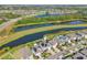 Aerial view of home with water view in a suburban neighborhood with well-manicured lawns at 16946 Oval Rum Dr., Wimauma, FL 33598