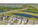 Aerial view of neighborhood featuring homes with well-maintained lawns and natural water features at 16946 Oval Rum Dr., Wimauma, FL 33598
