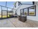 Covered patio with tiled flooring, an outdoor kitchen, barbecue, and a table with four chairs at 16946 Oval Rum Dr., Wimauma, FL 33598