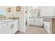 Elegant bathroom featuring dual vanities, granite countertops, and a luxurious bathtub at 16946 Oval Rum Dr., Wimauma, FL 33598