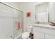 Bathroom featuring a glass-enclosed shower, modern toilet, and vanity with a large mirror at 16946 Oval Rum Dr., Wimauma, FL 33598