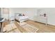Well-lit bedroom with modern furniture, hardwood floors, and ample space, perfect for relaxation at 16946 Oval Rum Dr., Wimauma, FL 33598
