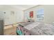 Bright bedroom with wood flooring, two windows and an artistic picture at 16946 Oval Rum Dr., Wimauma, FL 33598