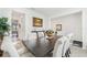 Bright dining room featuring a table with seating for six, views of adjacent rooms, and elegant decor at 16946 Oval Rum Dr., Wimauma, FL 33598