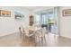 Bright dining area with a marble table, seating for six, and sliding glass doors to an outdoor patio at 16946 Oval Rum Dr., Wimauma, FL 33598