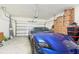 Spacious garage with a blue car parked inside and plenty of storage space at 16946 Oval Rum Dr., Wimauma, FL 33598