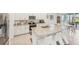 Stylish kitchen featuring granite counters, stainless steel appliances, bar seating, and a view to the outside patio at 16946 Oval Rum Dr., Wimauma, FL 33598