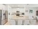Modern kitchen featuring stainless steel appliances, granite countertops, a central island, and barstool seating at 16946 Oval Rum Dr., Wimauma, FL 33598