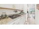 Kitchen detail with granite counters, decorative signs, and modern appliances, showcasing a blend of style and function at 16946 Oval Rum Dr., Wimauma, FL 33598