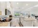 Bright, open kitchen with granite counters, stainless appliances, and seamless flow to dining and living areas at 16946 Oval Rum Dr., Wimauma, FL 33598