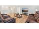Open floor plan showing living room with wood floors and comfortable reclining sofa at 16946 Oval Rum Dr., Wimauma, FL 33598