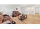 Living room with comfortable, reclining sofa, wood-look floors, and coffee table at 16946 Oval Rum Dr., Wimauma, FL 33598