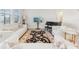 Bright living room featuring a piano, plush seating, elegant rug, and large windows at 16946 Oval Rum Dr., Wimauma, FL 33598