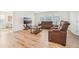 Spacious living room with wood floors and brown leather recliners at 16946 Oval Rum Dr., Wimauma, FL 33598