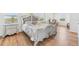 Bright main bedroom featuring a decorative bed frame and hardwood floors at 16946 Oval Rum Dr., Wimauma, FL 33598