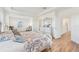 Spacious main bedroom with seating area, wood floors, and a decorative bed frame at 16946 Oval Rum Dr., Wimauma, FL 33598