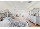 Main bedroom with tray ceiling, hardwood floors and an ornate bed frame at 16946 Oval Rum Dr., Wimauma, FL 33598
