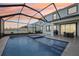 Stunning screened pool with a spa and elegant patio, ideal for relaxation and outdoor gatherings at 16946 Oval Rum Dr., Wimauma, FL 33598