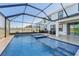 Beautiful backyard pool and spa combination enclosed in a screened enclosure with patio area at 16946 Oval Rum Dr., Wimauma, FL 33598