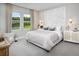 This neutral bedroom includes a window with a view of the lake and a decor piece on the wall at 17420 Moonflower Dr # 101, Venice, FL 34293