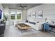 Bright living room showcasing modern decor, large windows overlooking outdoor scenery and comfortable seating area at 17420 Moonflower Dr # 102, Venice, FL 34293