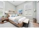 Inviting bedroom with a wood bed frame, bedside tables, and a bench at 19223 Wind Dancer St, Lutz, FL 33558