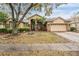 Inviting single-Gathering home featuring manicured landscaping, a two-car garage, and an inviting front entrance at 19223 Wind Dancer St, Lutz, FL 33558