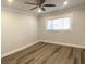 Empty bedroom with wood-look floors, crown molding, and ceiling fan, ready for personalization at 2022 Camelot Dr # 9, Clearwater, FL 33763