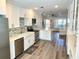 Spacious kitchen featuring white cabinets, stainless steel appliances, and an open layout to the living area at 2022 Camelot Dr # 9, Clearwater, FL 33763