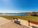 Beautiful lake view with benches, a sidewalk, and lush green grass at 2022 Camelot Dr # 9, Clearwater, FL 33763