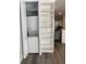 Convenient closet laundry area with stackable washer and dryer unit, next to shelves at 2022 Camelot Dr # 9, Clearwater, FL 33763