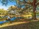 Picturesque pond surrounded by lush trees and greenery, creating a serene atmosphere at 2022 Camelot Dr # 9, Clearwater, FL 33763