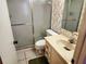 Bathroom featuring a tiled shower with sliding glass doors, toilet, and a sink vanity at 205 Dogwood Cir # 205, Seminole, FL 33777