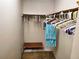 Walk-in closet with hanging racks, bench, and room for organization and storage at 205 Dogwood Cir # 205, Seminole, FL 33777