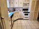 Kitchen featuring white cabinets, tile floor and view of the appliances at 205 Dogwood Cir # 205, Seminole, FL 33777