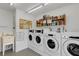 Clean laundry room with multiple machines and shelving at 205 Dogwood Cir # 205, Seminole, FL 33777