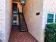Stairwell leading to the units with tiled floor and building address at 205 Dogwood Cir # 205, Seminole, FL 33777