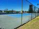 Well-maintained tennis court with surrounding fence and greenery at 205 Dogwood Cir # 205, Seminole, FL 33777