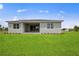 Spacious backyard with a covered patio, perfect for outdoor living at 24041 Peppercorn Rd, Punta Gorda, FL 33955