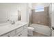 Modern bathroom features a single sink vanity, large mirror, and a shower-tub combination with tiled walls at 24041 Peppercorn Rd, Punta Gorda, FL 33955