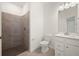 Modern bathroom with sleek shower, vanity and tiled floor at 24041 Peppercorn Rd, Punta Gorda, FL 33955