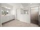 Bathroom featuring tile flooring, shower, and vanity with mirror and lights at 24041 Peppercorn Rd, Punta Gorda, FL 33955